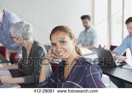Stock Image - Portrait confident adult education student in classroom. Fotosearch