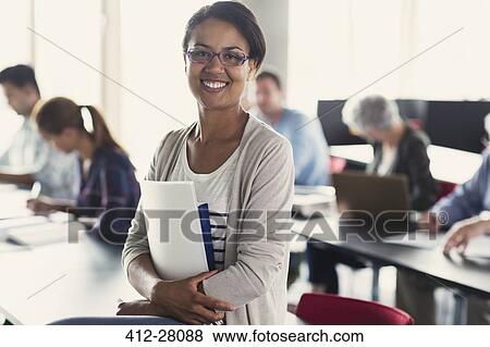 Portrait confident adult education student with books in classroom View Large Photo Image Stock Photo - Portrait confident adult education student with books in classroom. Fotosearch