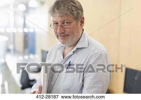 Stock Photo - Portrait confident businessman with notebook. Fotosearch