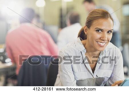 Portrait confident businesswoman in office View Large Photo Image Stock Image - Portrait confident businesswoman in office. Fotosearch