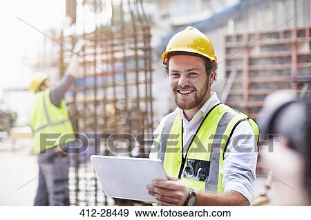 Portrait confident construction worker with digital tablet at construction site View Large Photo Image Stock Photo - Portrait confident construction worker with digital tablet at construction site. Fotosearch