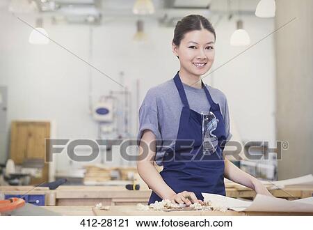 Stock Image - Portrait confident female carpenter in workshop. Fotosearch