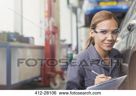 Portrait confident female mechanic with clipboard in auto repair shop View Large Photo Image Stock Photograph - Portrait confident female mechanic with clipboard in auto repair shop. Fotosearch