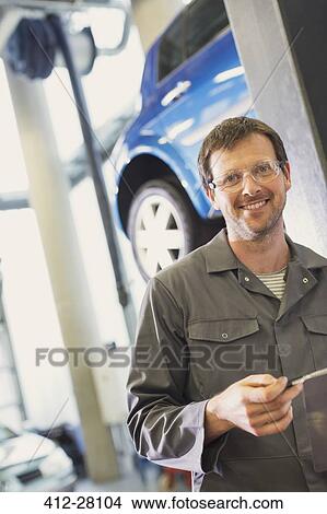 Picture - Portrait confident mechanic in auto repair shop. Fotosearch