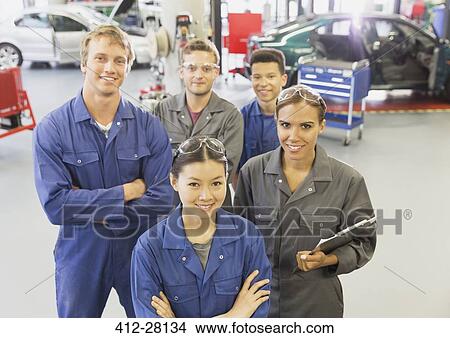 Portrait confident mechanics in auto repair shop View Large Photo Image Picture - Portrait confident mechanics in auto repair shop. Fotosearch