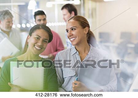 Stock Photograph - Portrait confident women in adult education classroom. Fotosearch