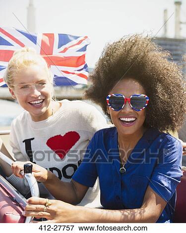 Portrait enthusiastic friends with British flag riding double-decker bus View Large Photo Image Stock Photo - Portrait enthusiastic friends with British flag riding double-decker bus. Fotosearch