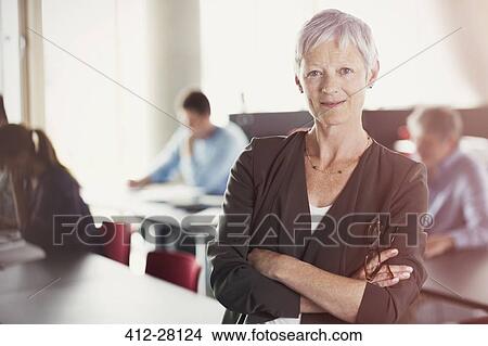Portrait of confident senior woman in adult education classroom View Large Photo Image Picture - Portrait of confident senior woman in adult education classroom. Fotosearch
