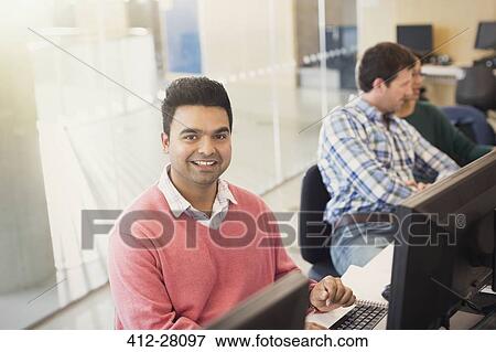 Portrait smiling adult education student at computer in classroom View Large Photo Image Stock Photo - Portrait smiling adult education student at computer in classroom. Fotosearch