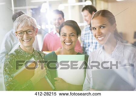 Portrait smiling businesswomen with notebooks View Large Photo Image Stock Photography - Portrait smiling businesswomen with notebooks. Fotosearch