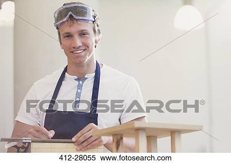 Stock Photography - Portrait smiling carpenter in workshop. Fotosearch