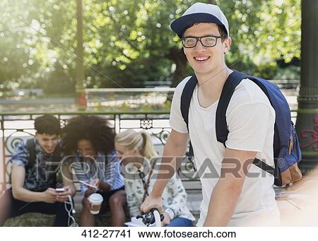 Portrait smiling man with eyeglasses in park View Large Photo Image Stock Image - Portrait smiling man with eyeglasses in park. Fotosearch
