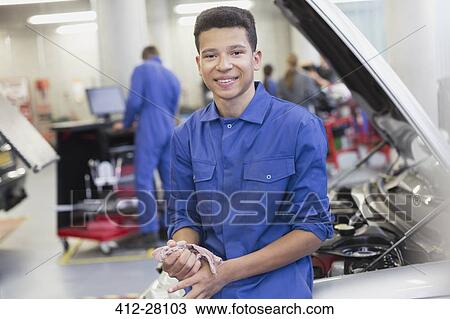 Portrait smiling mechanic leaning on car in auto repair shop View Large Photo Image Stock Image - Portrait smiling mechanic leaning on car in auto repair shop. Fotosearch