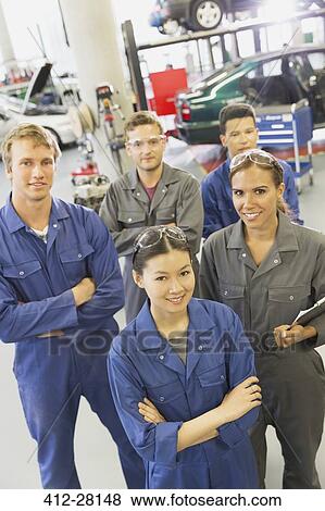 Portrait smiling mechanics in auto repair shop View Large Photo Image Stock Photo - Portrait smiling mechanics in auto repair shop. Fotosearch