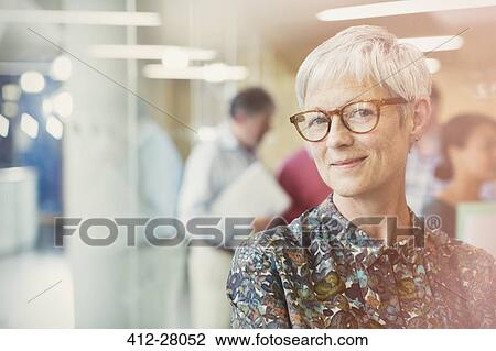 Portrait smiling senior businesswoman in office View Large Photo Image Stock Image - Portrait smiling senior businesswoman in office. Fotosearch
