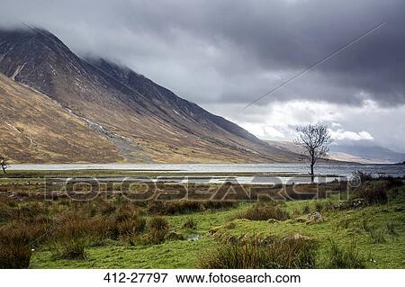 Stock Photo - Remote mountains and lake below overcast sky, Loch Etive, Argyll Scotland. Fotosearch