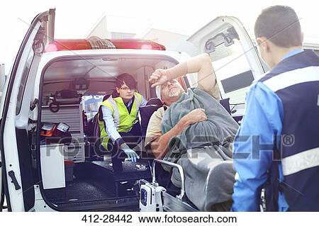 Rescue workers loading car accident victim into back of ambulance View Large Photo Image Stock Image - Rescue workers loading car accident victim into back of ambulance. Fotosearch