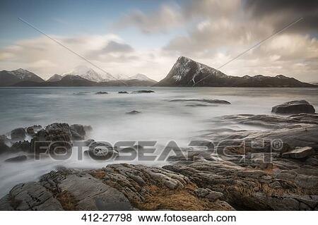 Scenic view mountains and cold craggy ocean, Vagje Lofoten Islands, Norway View Large Photo Image Stock Photo - Scenic view mountains and cold craggy ocean, Vagje Lofoten Islands, Norway. Fotosearch