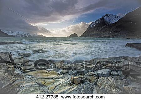 Stock Photography - Scenic view of craggy ocean bay and mountains, Haukland Lofoten Islands, Norway. Fotosearch