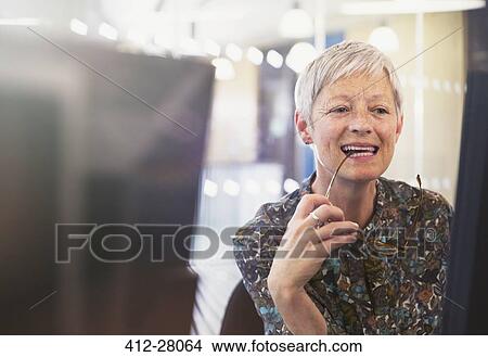Senior businesswoman working at computer in office View Large Photo Image Picture - Senior businesswoman working at computer in office. Fotosearch