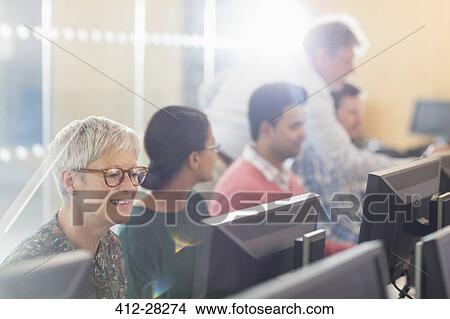 Senior woman at computer in adult education classroom View Large Photo Image Picture - Senior woman at computer in adult education classroom. Fotosearch