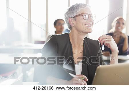 Smiling senior woman at laptop in adult education classroom View Large Photo Image Stock Photograph - Smiling senior woman at laptop in adult education classroom. Fotosearch