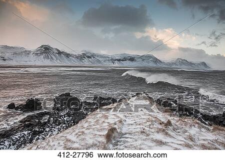 Snow covered mountain range over cold ocean, Budir, Snaefellsnes, Iceland View Large Photo Image Stock Photograph - Snow covered mountain range over cold ocean, Budir, Snaefellsnes, Iceland. Fotosearch