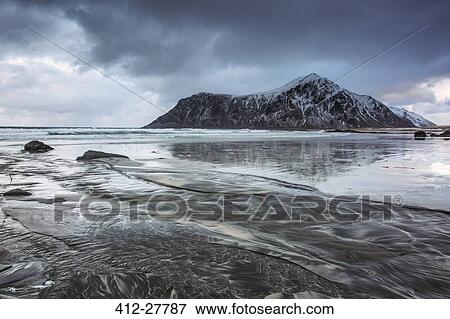 Snow covered rock formation on cold ocean beach, Skagsanden Beach, Lofoten Islands, Norway View Large Photo Image Stock Photo - Snow covered rock formation on cold ocean beach, Skagsanden Beach, Lofoten Islands, Norway. Fotosearch