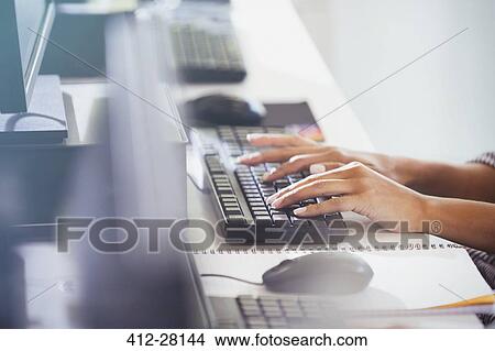 Student typing on computer keyboard in adult education classroom View Large Photo Image Picture - Student typing on computer keyboard in adult education classroom. Fotosearch