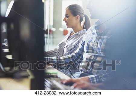 Stock Image - Students at computers in adult education classroom. Fotosearch