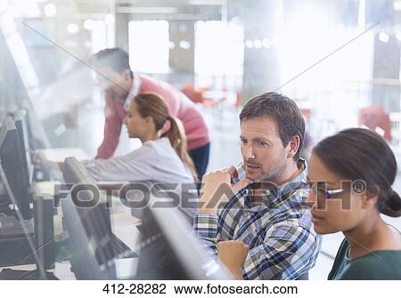 Stock Image - Students at computers in adult education classroom. Fotosearch