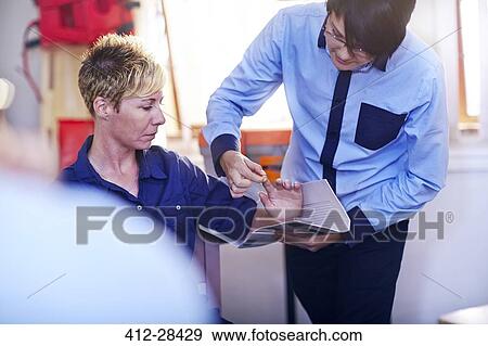 Stock Photo - Students practicing making medical splint in training class. Fotosearch