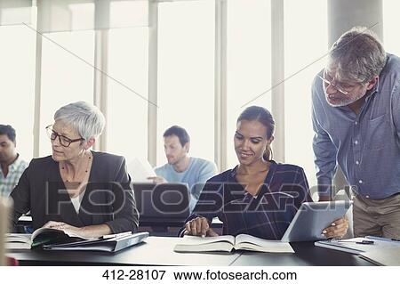 Stock Photo - Students studying in adult education classroom. Fotosearch