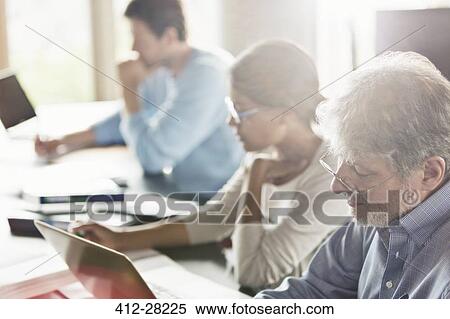 Stock Photography - Students studying in adult education classroom. Fotosearch