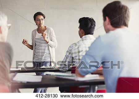 Teacher speaking to students in adult education classroom View Large Photo Image Stock Image - Teacher speaking to students in adult education classroom. Fotosearch