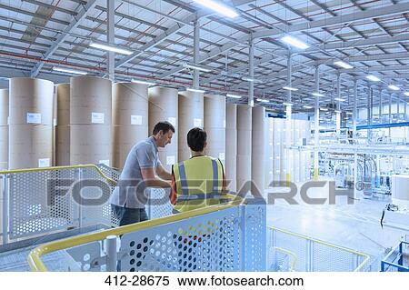 Workers talking on platform above factory View Large Photo Image Stock Photography - Workers talking on platform above factory. Fotosearch