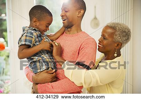 Affectionate multi-generation family hugging View Large Photo Image Stock Photo - Affectionate multi-generation family hugging. Fotosearch