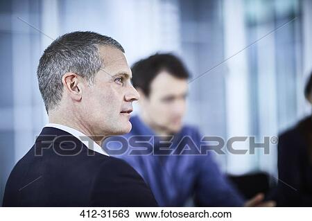 Stock Image - Attentive businessman listening in meeting. Fotosearch