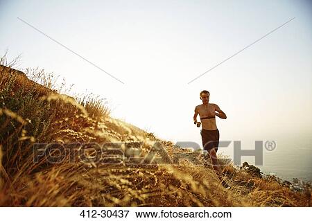 Bare chested man running on sunny hillside View Large Photo Image Stock Photo - Bare chested man running on sunny hillside. Fotosearch