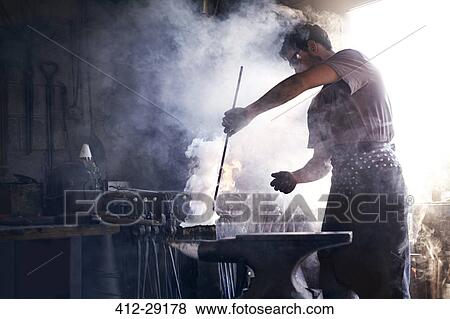 Blacksmith heating iron tool in forge View Large Photo Image Stock Photo - Blacksmith heating iron tool in forge. Fotosearch