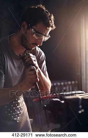 Blacksmith shaping tool in forge View Large Photo Image Stock Image - Blacksmith shaping tool in forge. Fotosearch