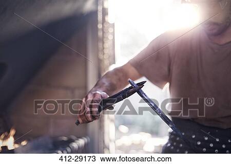 Blacksmith shaping tool with pliers in forge View Large Photo Image Stock Image - Blacksmith shaping tool with pliers in forge. Fotosearch