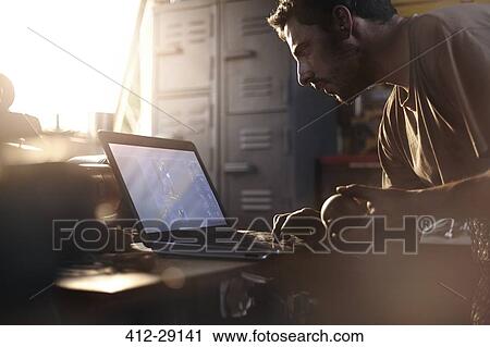Blacksmith using laptop in forge View Large Photo Image Stock Image - Blacksmith using laptop in forge. Fotosearch
