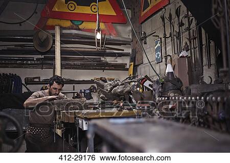 Stock Photograph - Blacksmith working in forge. Fotosearch