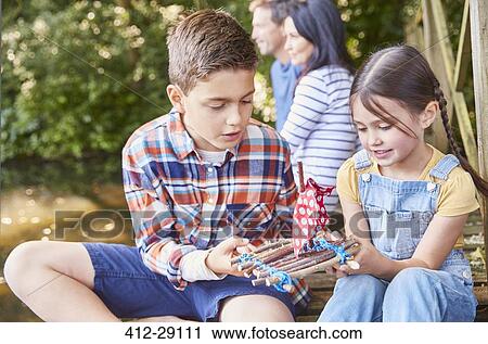 Brother and sister assembling toy wooden raft View Large Photo Image Stock Image - Brother and sister assembling toy wooden raft. Fotosearch