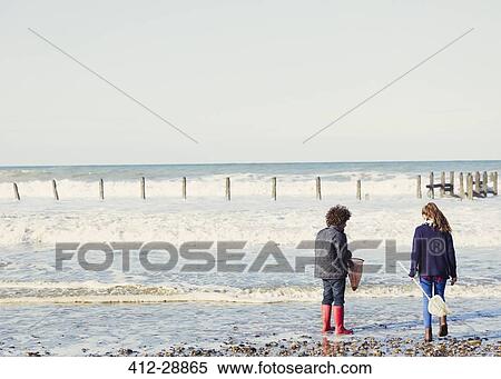 Brother and sister with nets in ocean surf View Large Photo Image Stock Photography - Brother and sister with nets in ocean surf. Fotosearch