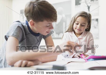 Stock Photography - Brother helping sister with homework. Fotosearch