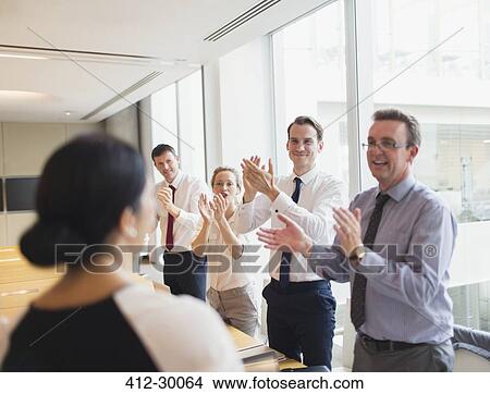 Business people clapping for businesswoman in conference room View Large Photo Image Picture - Business people clapping for businesswoman in conference room. Fotosearch