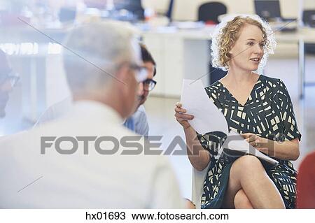 Business people discussing paperwork in meeting View Large Photo Image Stock Image - Business people discussing paperwork in meeting. Fotosearch