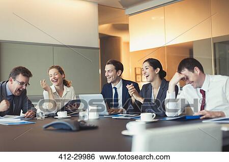 Business people laughing in conference room meeting View Large Photo Image Stock Photograph - Business people laughing in conference room meeting. Fotosearch